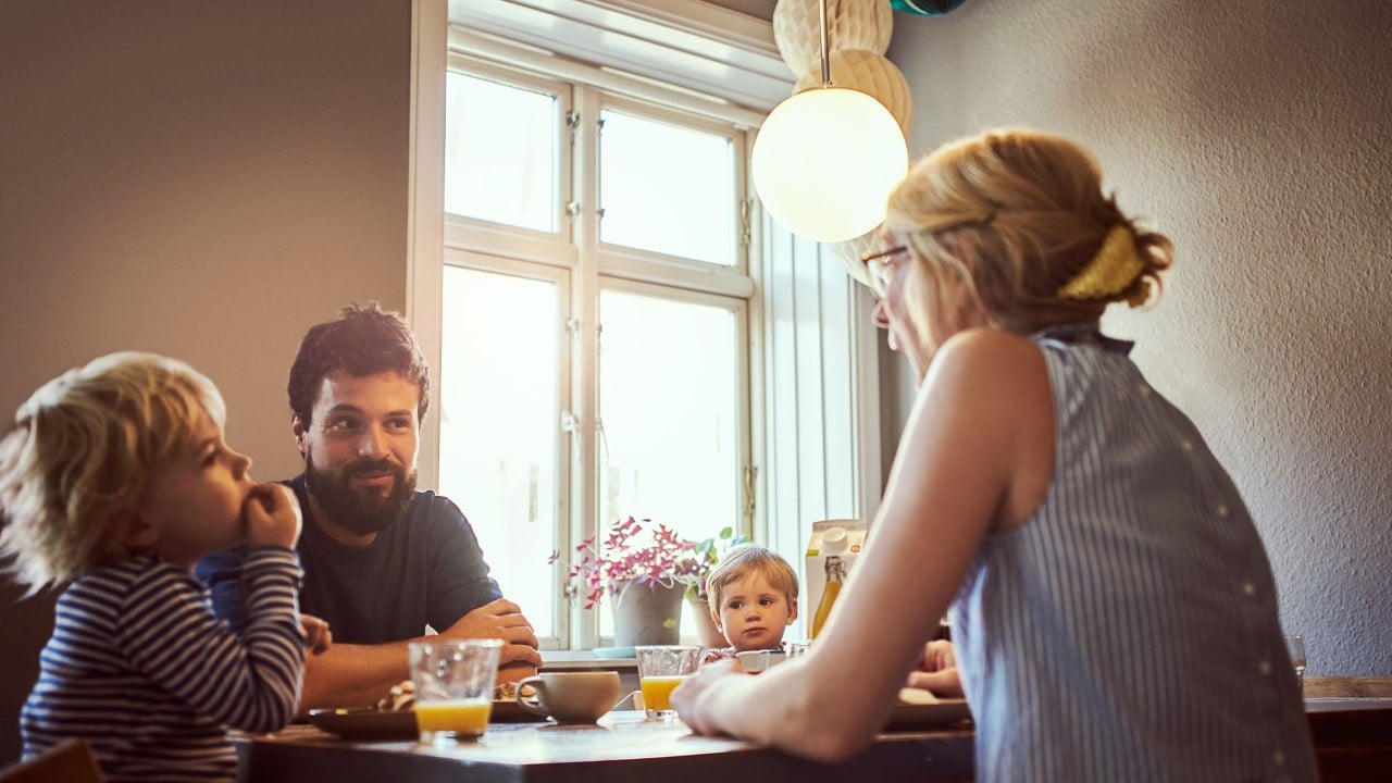 Lykkelig familie ved frokostbordet
