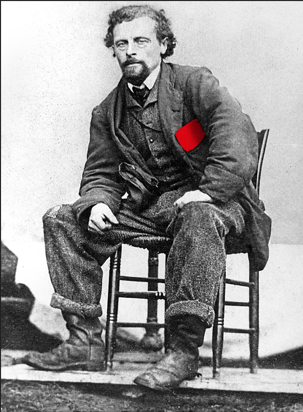 Bildet viser et svart-hvitt portrett av Marcus Thrane som sitter fremoverlent i en stol. I venstre brystlomme stråler et rødt lommetørkle som et symbol på hans lidenskap for arbeiderbevegelsen.